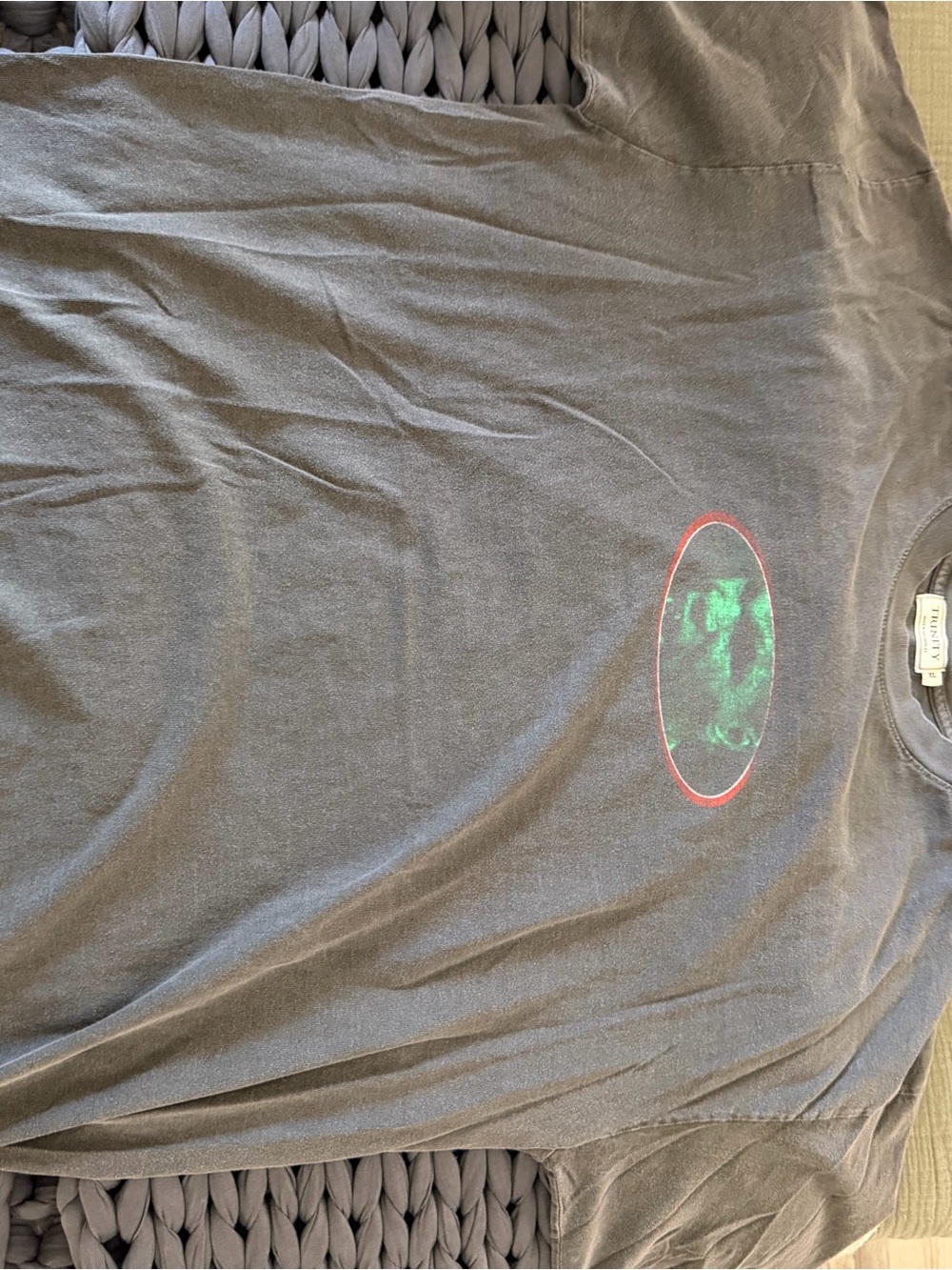 Trinity Black Short Sleeve Tee with Green Oval Graphic and Red Ring
